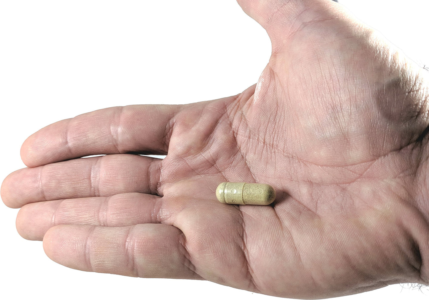 Cápsula de suplemento inmune sobre una mano.