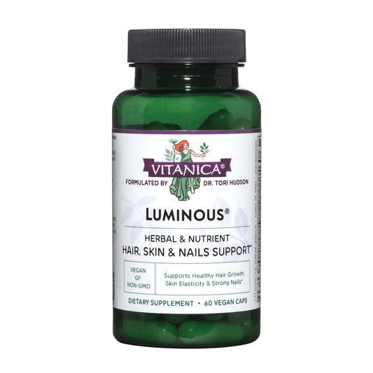 botella verde de luminarias vitaminas veganas