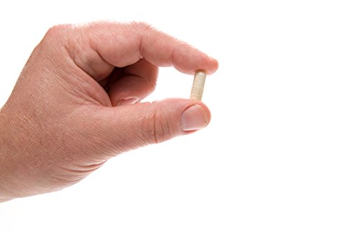 Cápsulas bloqueador DHT HairOmega DrFormulas en mano