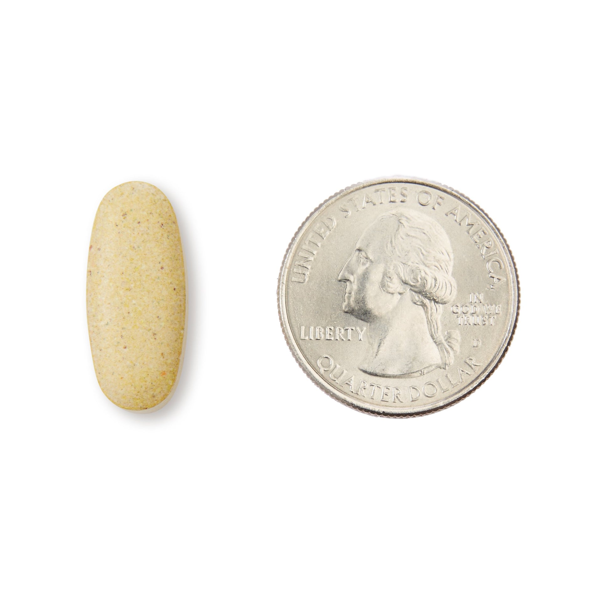 Tamaño de comprimido de multivitaminas junto a moneda